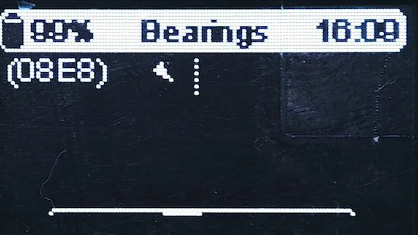 Meshtastic node OLED bearing screen with node ID and direction indicator